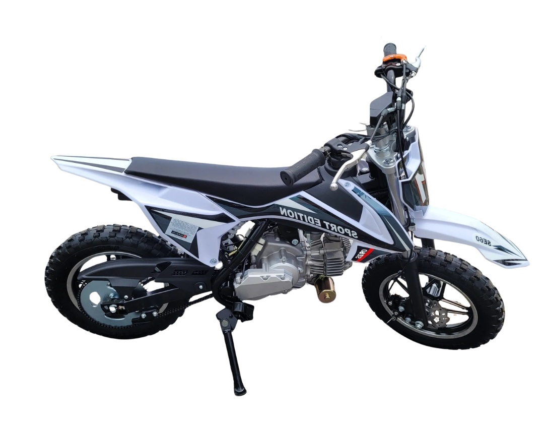 White and black off-road motorcycle with knobby tires on a stand against a plain white background