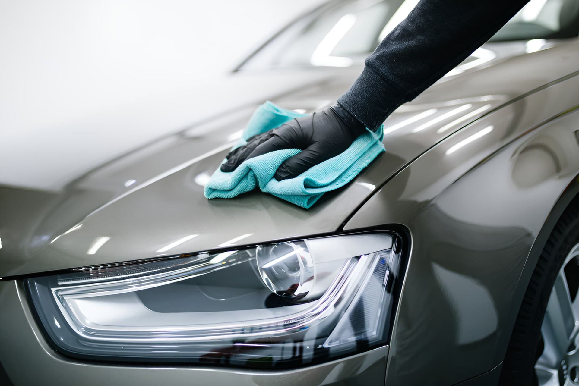 A Person Is Cleaning A Car With A Towel — Country Dirt Blasters Mobile Car Detailing In Murwillumbah, NSW