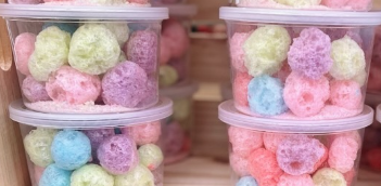 A stack of plastic containers filled with colorful cotton candy.