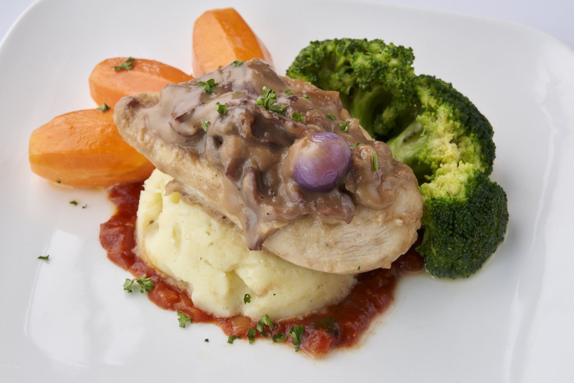Chicken with mushroom sauce, mashed potatoes, broccoli, and carrots