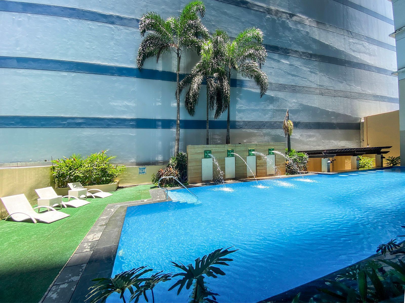 Swimming pool and lounge chairs at the Exchange Regency Hotel in Ortigas