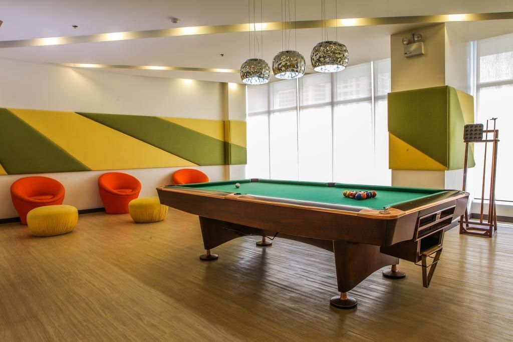 There is a pool table in the middle of the room.