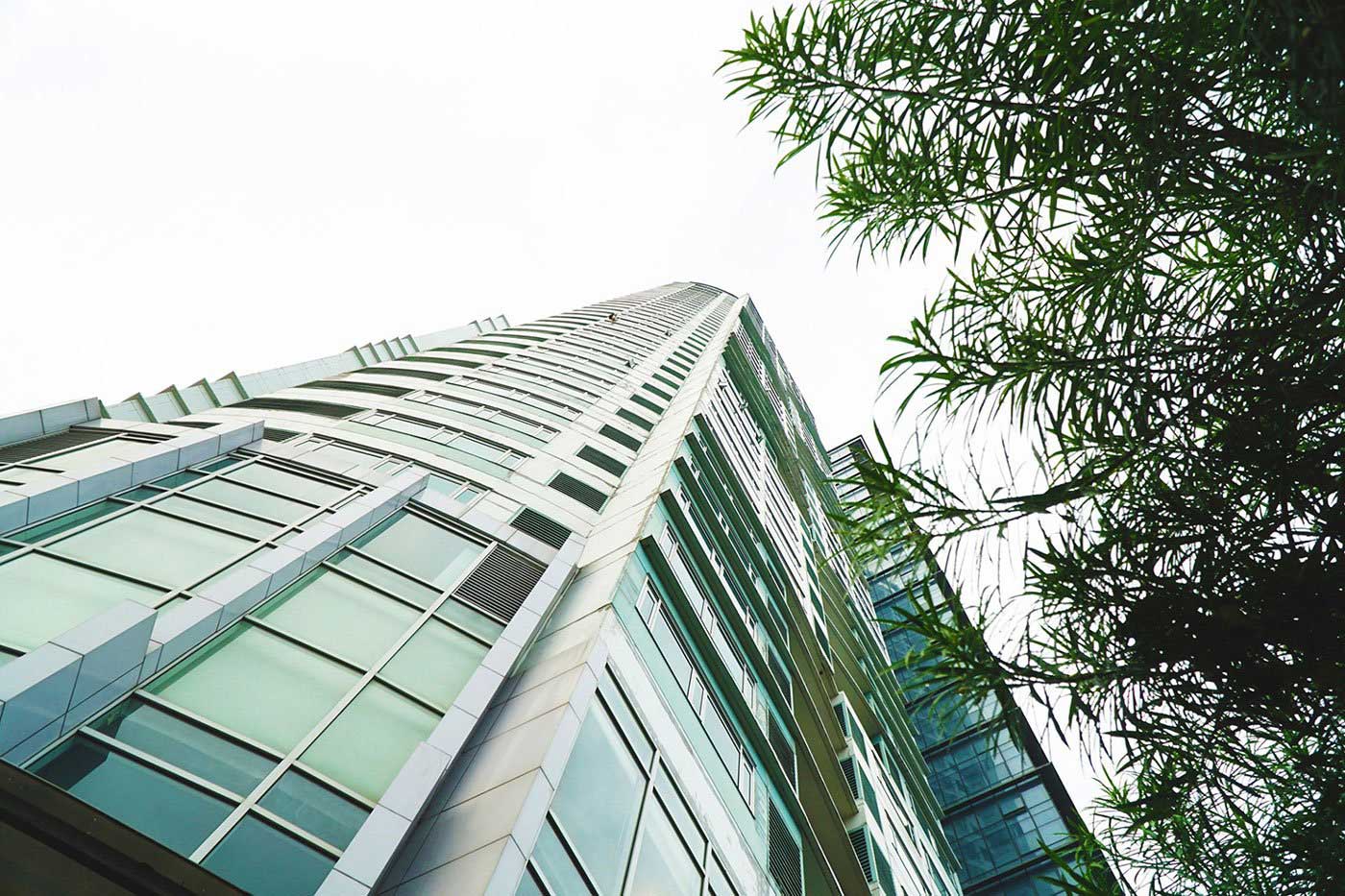 Looking up at a tall building with lots of windows