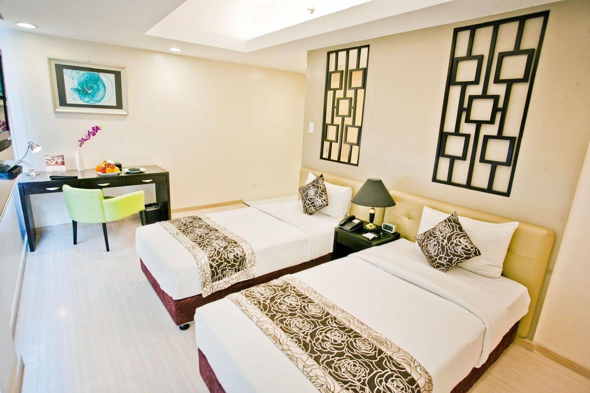 A hotel room with two beds and a desk