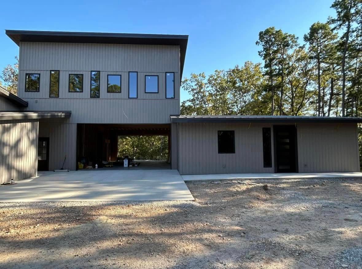 A gray house with a red deck and stairs