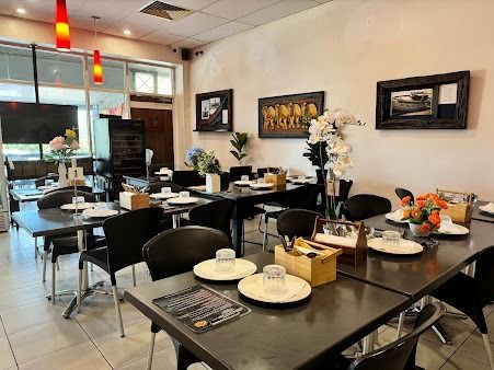 A Restaurant With Tables and Chairs Set Up for a Meal — Punjabi Sunrise Restaurant In Alexandra Hills, QLD