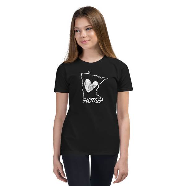 A girl wearing a black t-shirt that says home