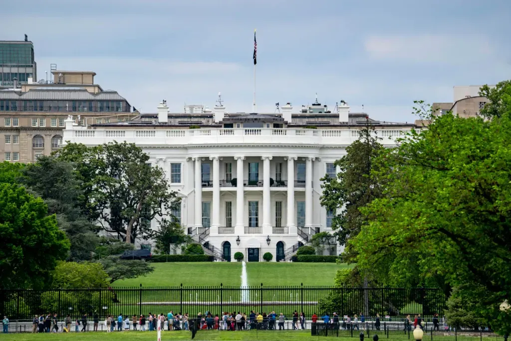 The White House in Washington, D.C., with green lawn and trees in the foreground
