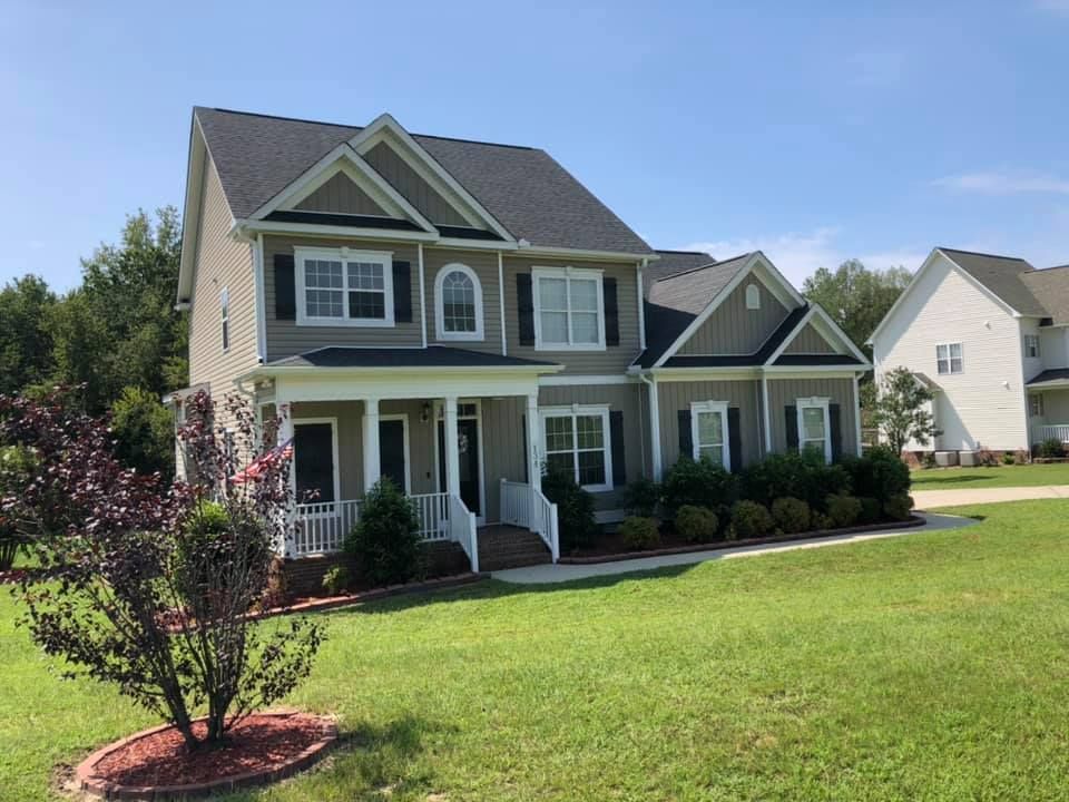 A large house with a large lawn in front of it
