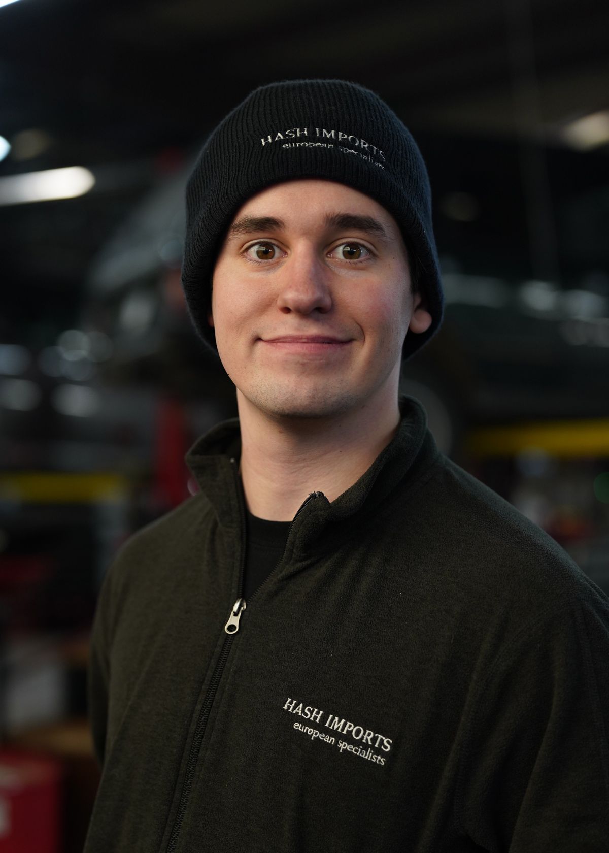 A person wearing a black beanie and fleece jacket with