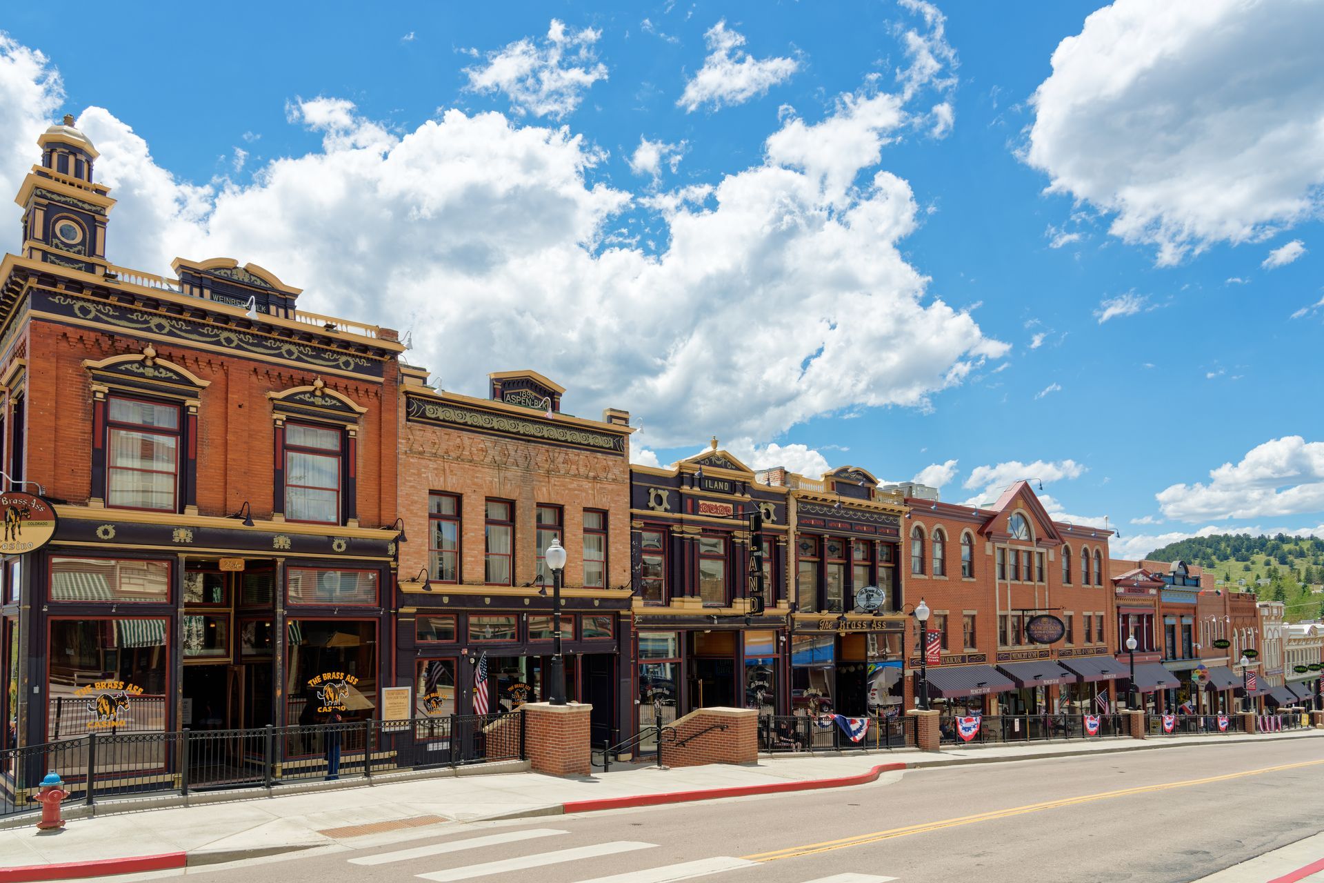 A row of buildings are lined up on the side of a street in a small town.