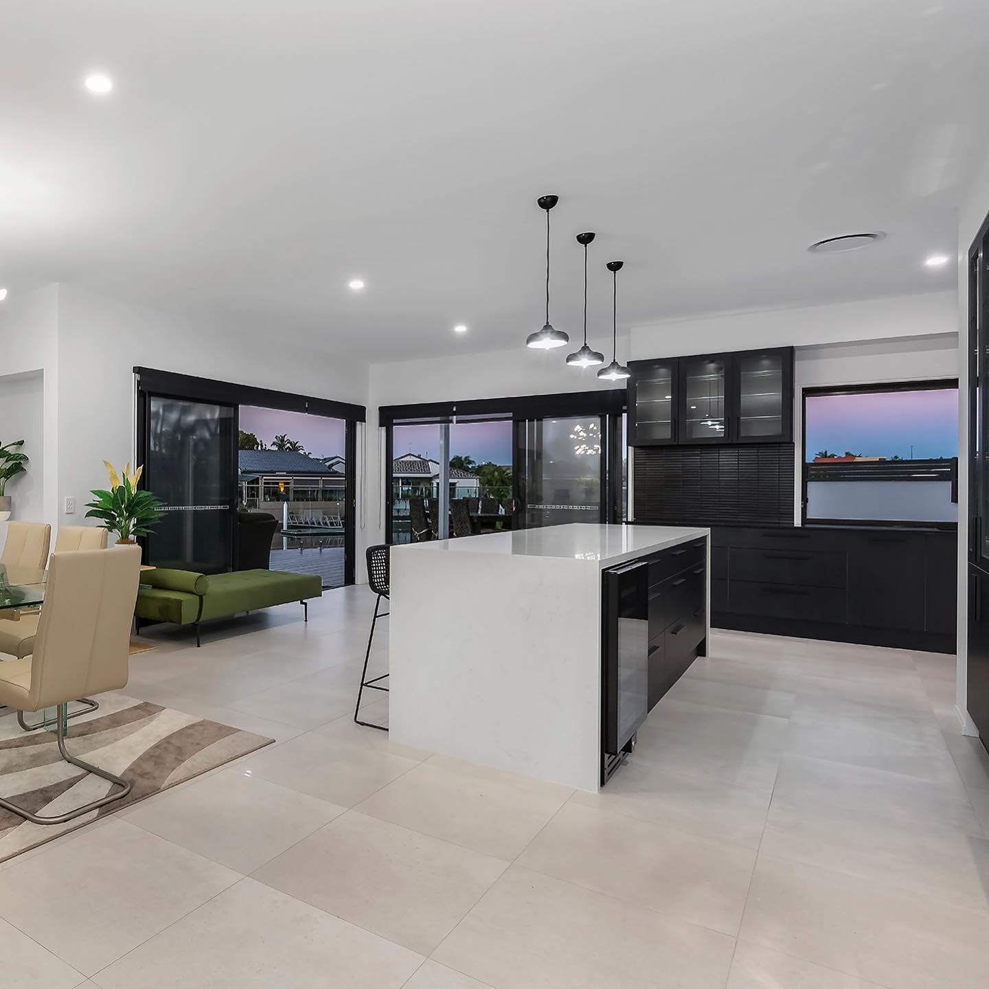Kitchen & Lounge Area With Black Cabinets — Interior Design in Tweed Heads, NSW