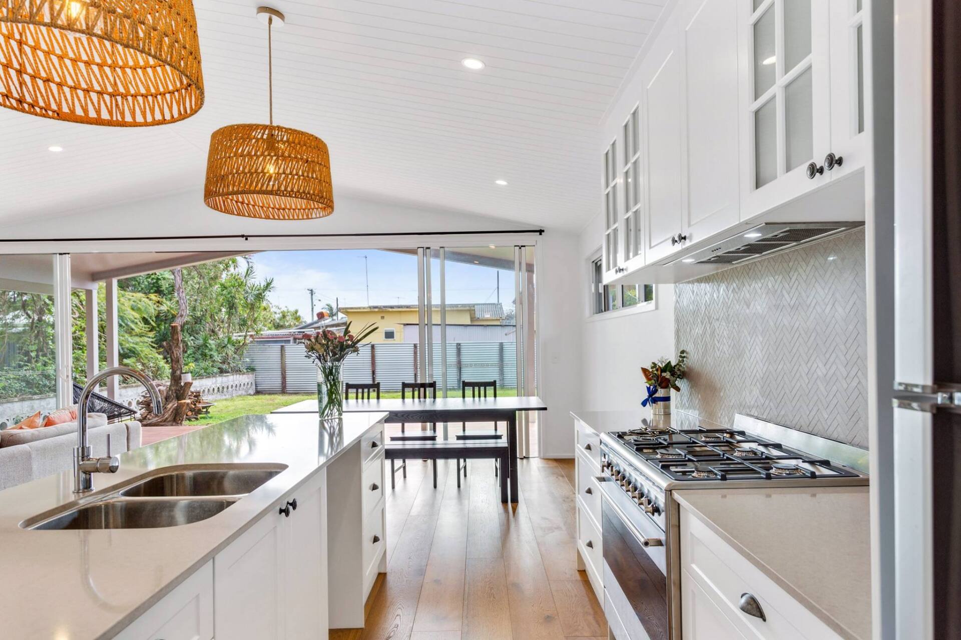 Modern White Kitchen Cabinets And Stainless Steel Appliances — Interior Design in Tweed Heads, NSW