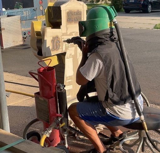 worker engraving a tomb stone