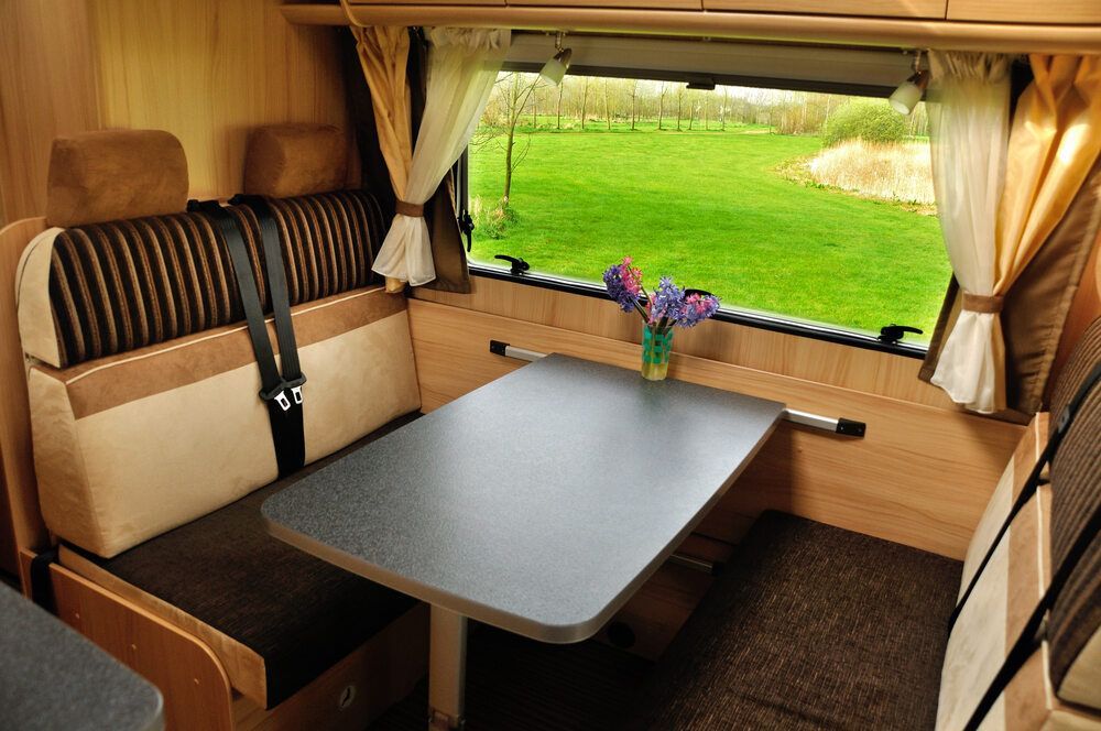 The Inside Of A Camper Van With A Table And A Window — Newcastle Air & Refrigeration in New Lambton, NSW