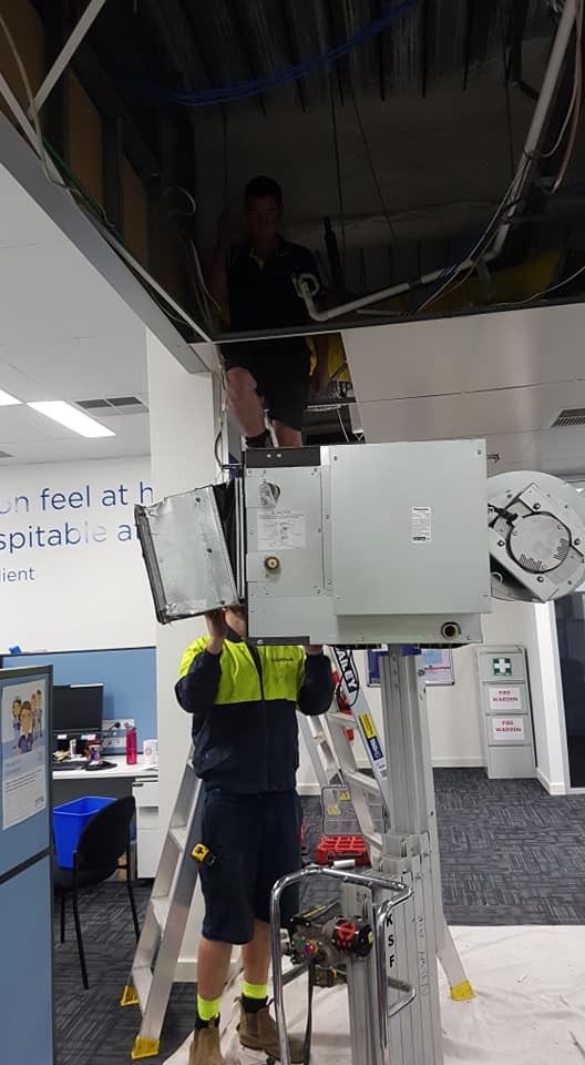 Technicians Installing Air Con — Newcastle Air & Refrigeration In New Lambton, NSW