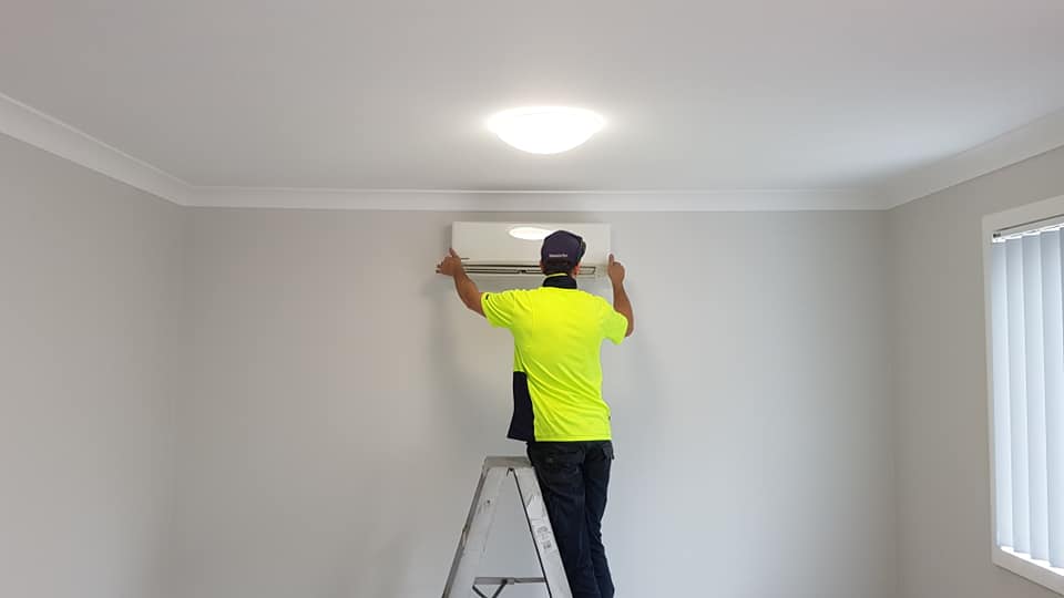 Technician Repairing Air Conditioner — Newcastle Air & Refrigeration In New Lambton, NSW