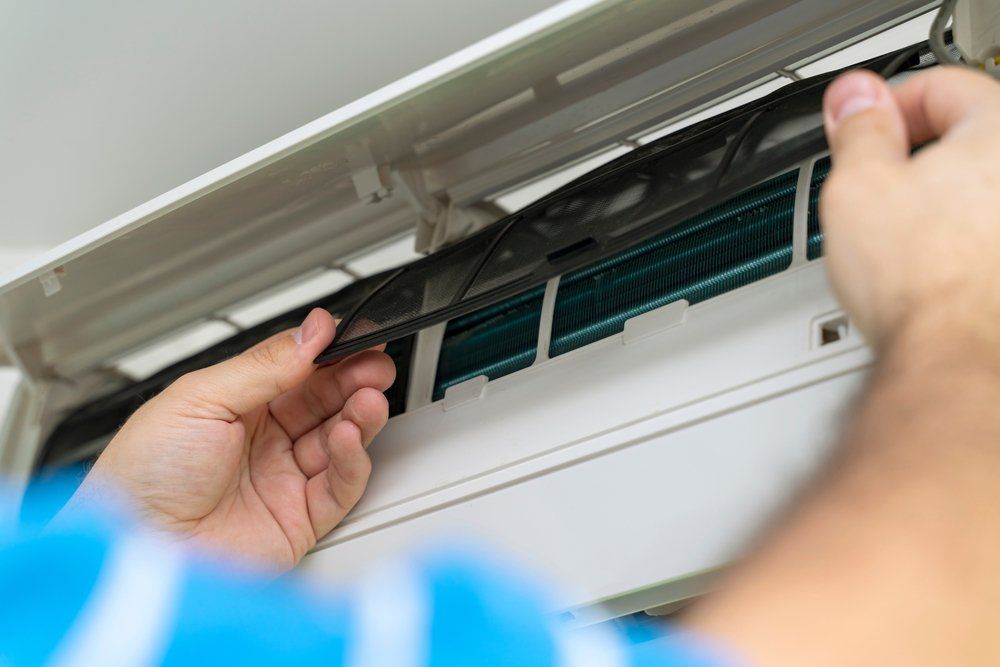 Technician Removing Air filter — Newcastle Air & Refrigeration In New Lambton, NSW