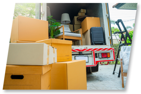 Boxes and furniture being loaded into a moving truck.