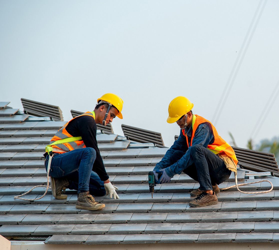 Workers Installing a Roof — Grand Junction, CO — Grand Junction Roofing Company Workers Installing a Roof — Grand Junction, CO — Grand Junction Roofing Company