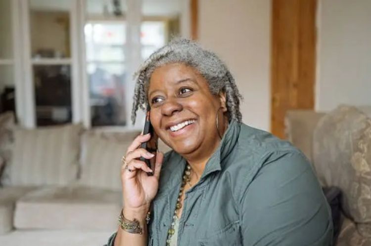Family member abroad staying connected with a loved one in Jamaica through the Family Bridge program
