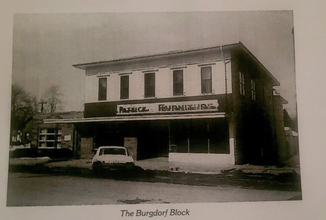The Dunghof Block, a two-story building with a flat roof, a sign that reads