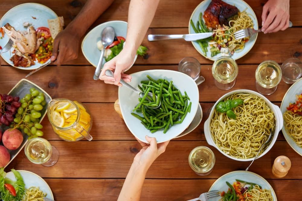 A Group of People Are Sitting at a Table Eating Food — Your Body Revolution in Caloundra, QLD