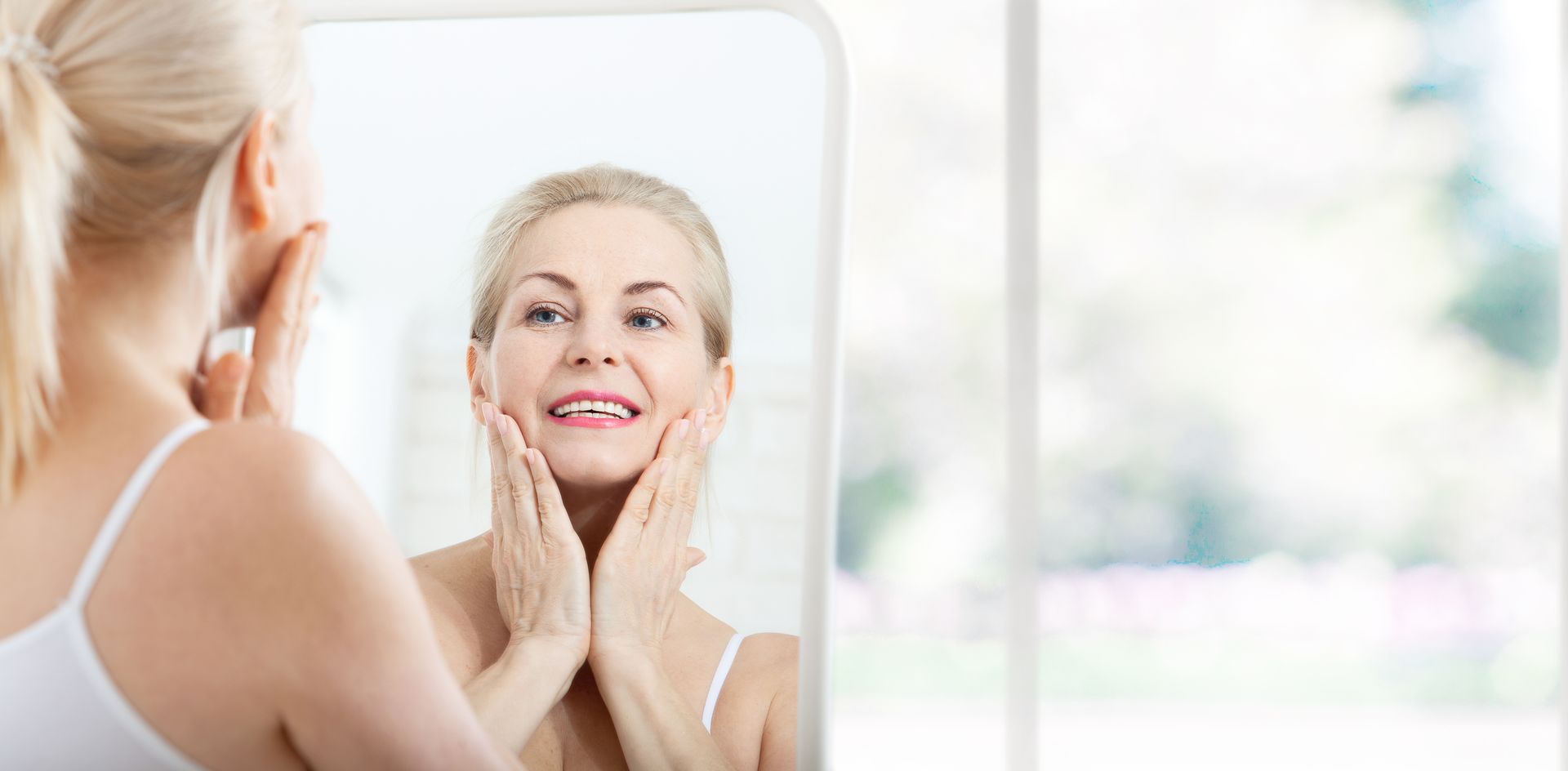 A Woman is Looking at Her Face in a Mirror — Your Body Revolution in Caloundra, QLD
