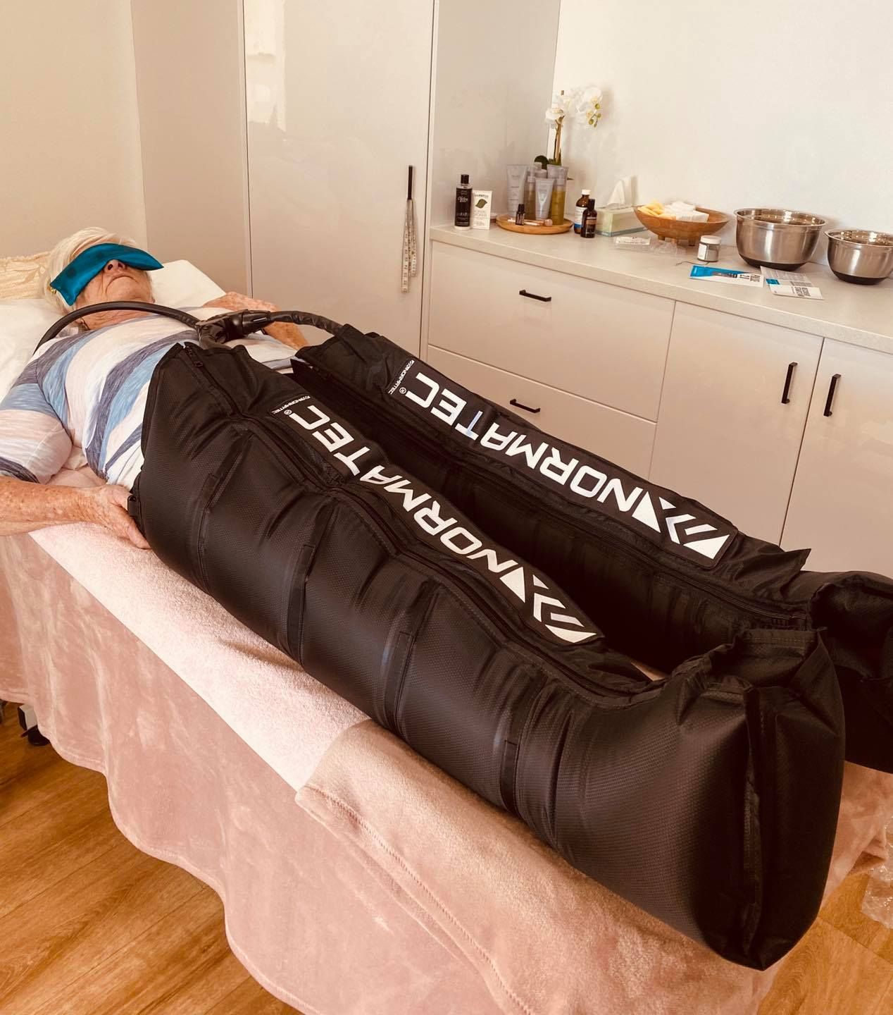 A Person is Laying on a Bed With Two Bags on Their Legs — Your Body Revolution in Caloundra, QLD
