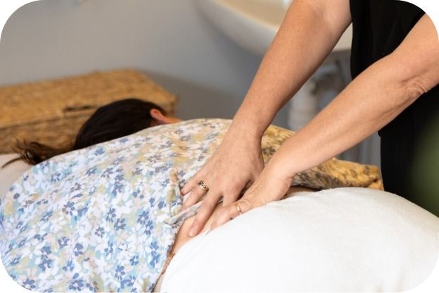 A Woman is Laying on a Bed Getting a Massage — Your Body Revolution in Caloundra, QLD
