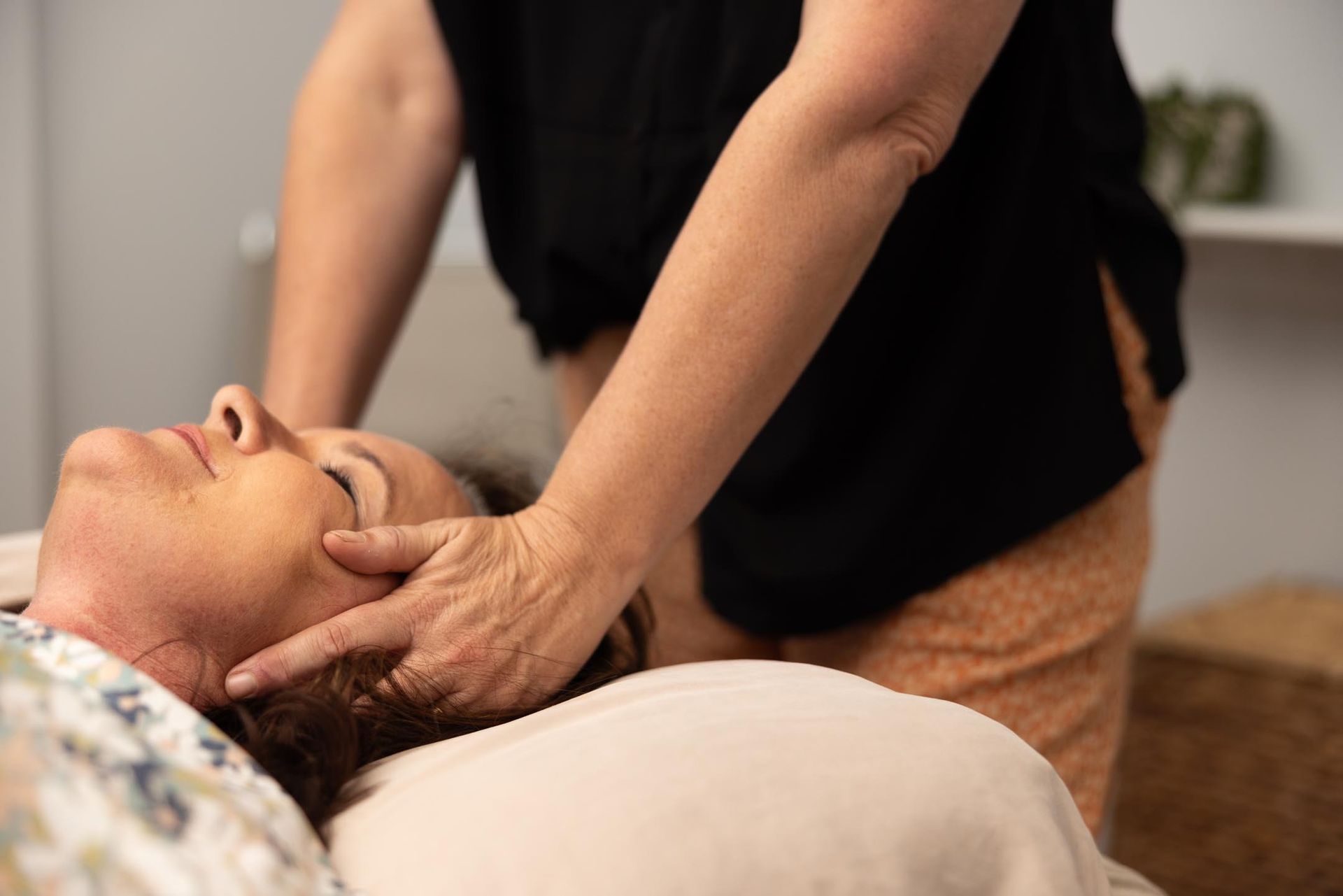 A Woman is Getting a Head Massage From a Massage Therapist — Your Body Revolution in Caloundra, QLD