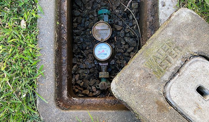 A row of brass pipes with gauges and valves on them
