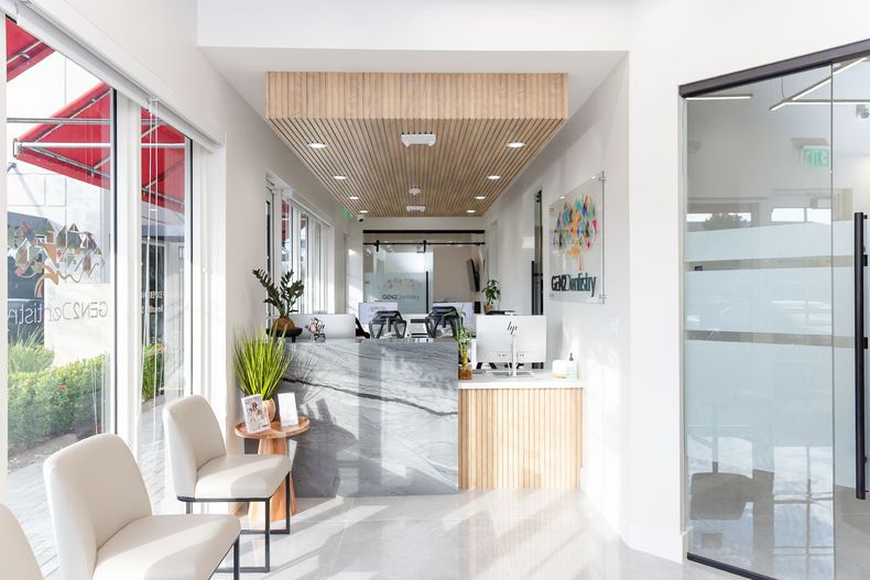 Bright modern café interior with white chairs, marble counter, and large windows