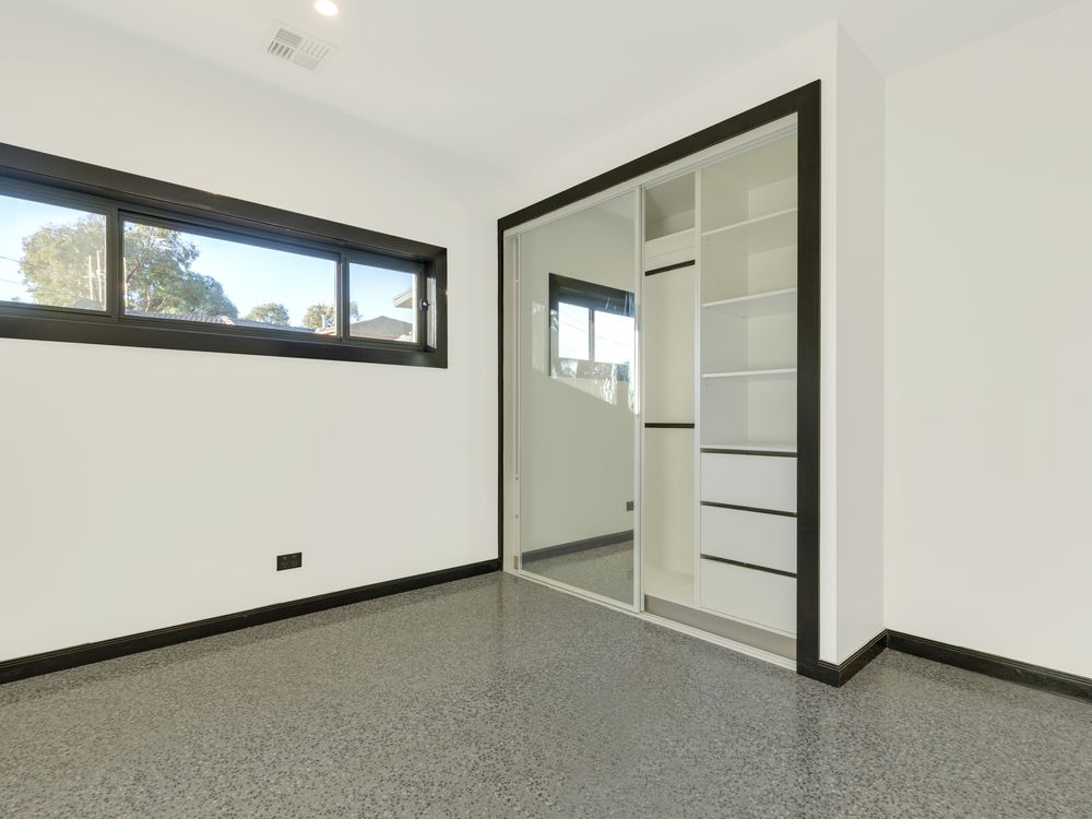 An Empty Room With A Sliding Glass Door And A Window — K & S Windows In Ciccone, NT