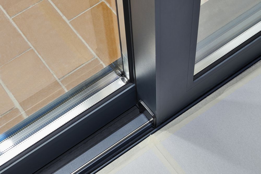 A Close Up Of A Sliding Glass Door On A Tiled Floor — K & S Windows In Ciccone, NT
