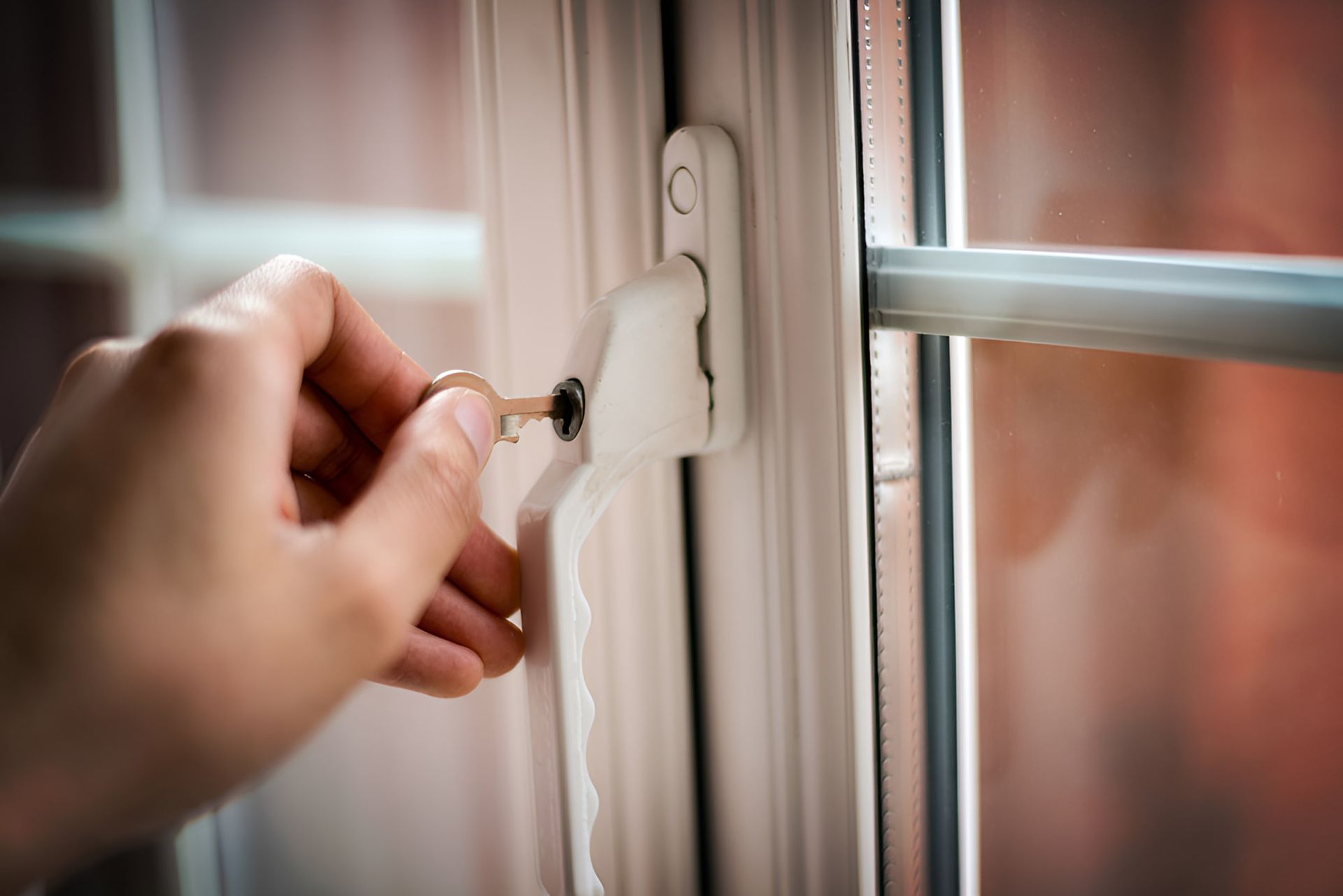 A Person Is Opening A Window With A Key — K & S Windows In Ciccone, NT