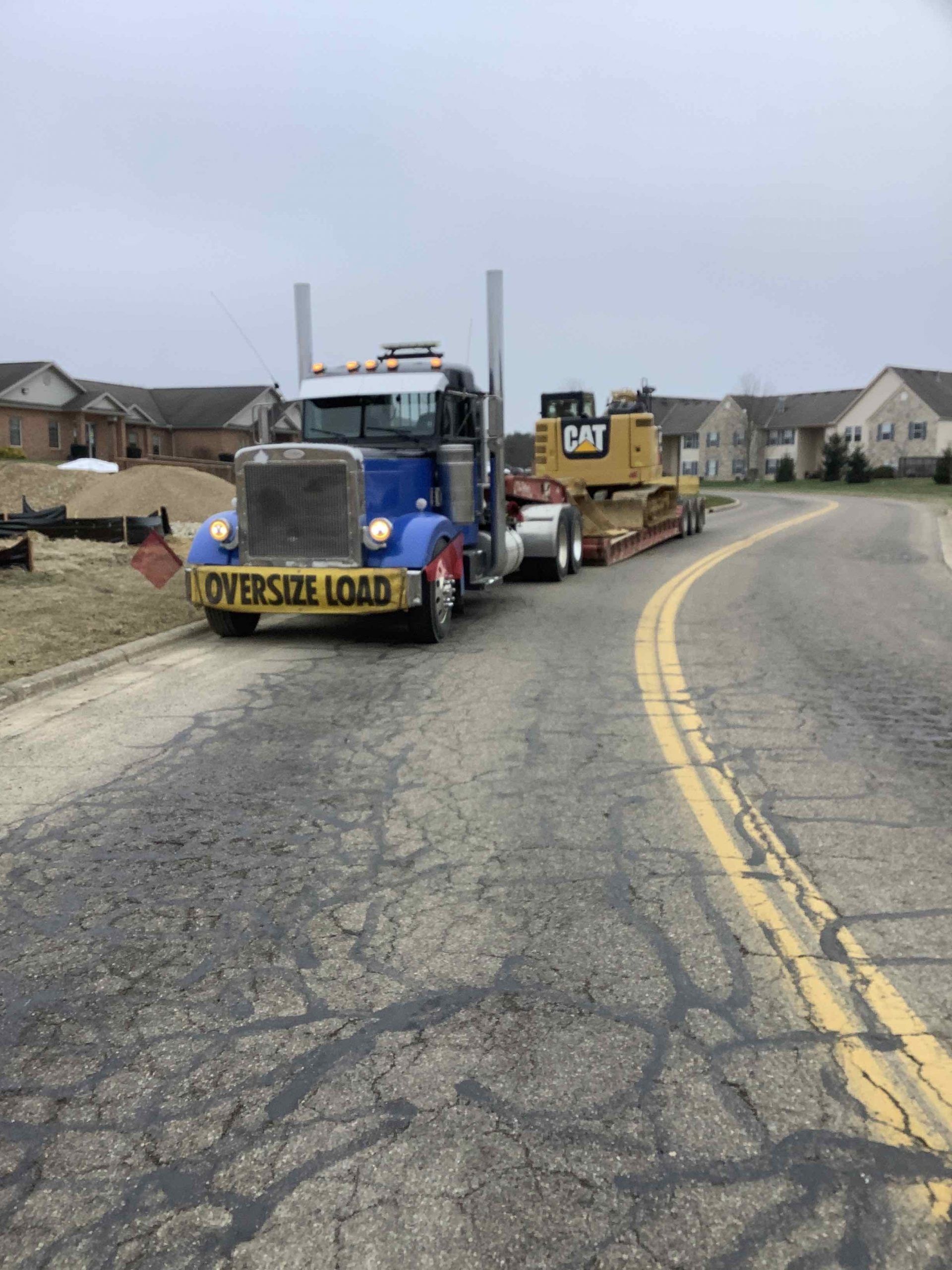 Truck hauling a Caterpillar bulldozer, marked 