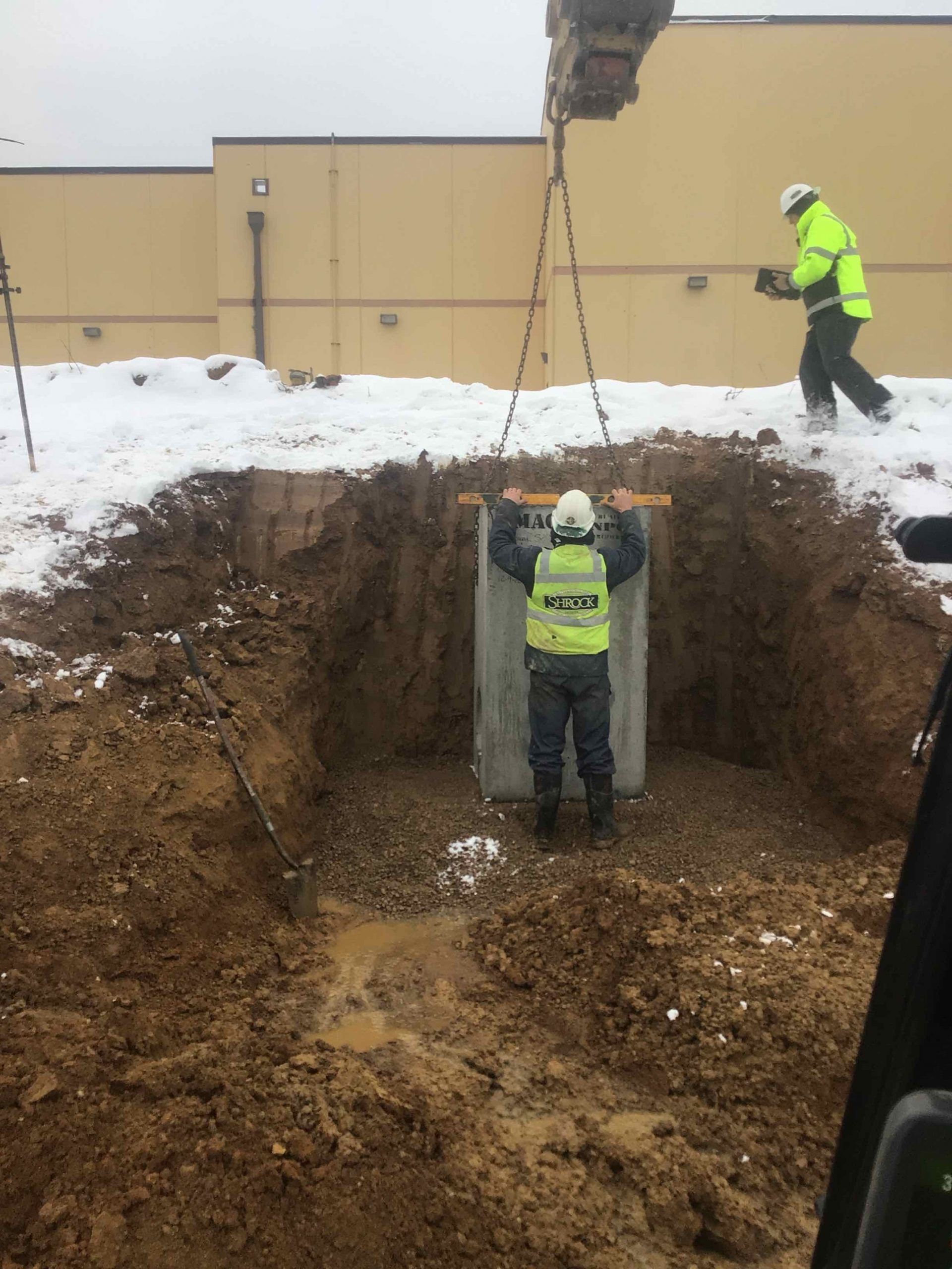 Shrock Excavating team surveying a new home site with stakes and dirt piles. Professional site prep in Ohio.