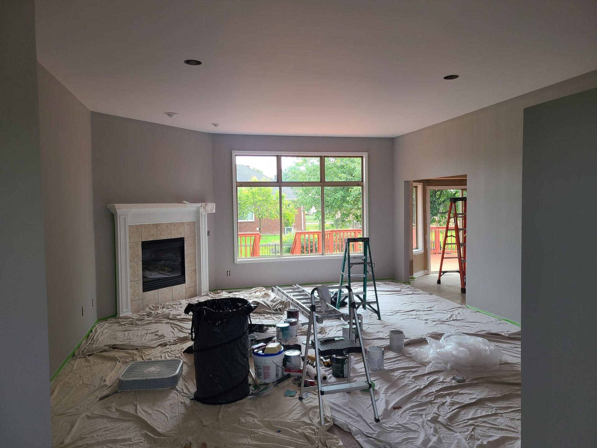 A living room is being painted in a house.