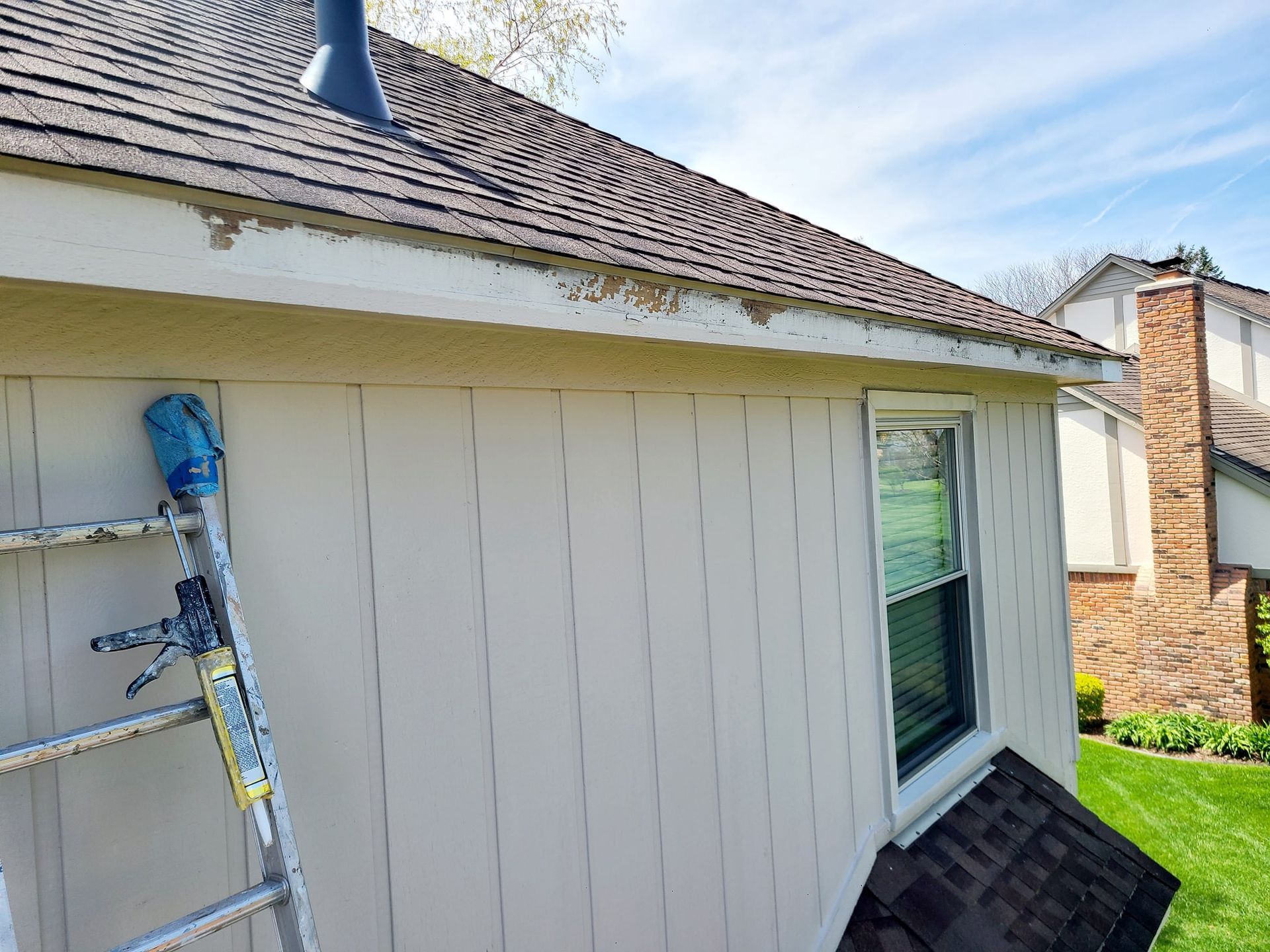 A ladder is leaning against the side of a house.