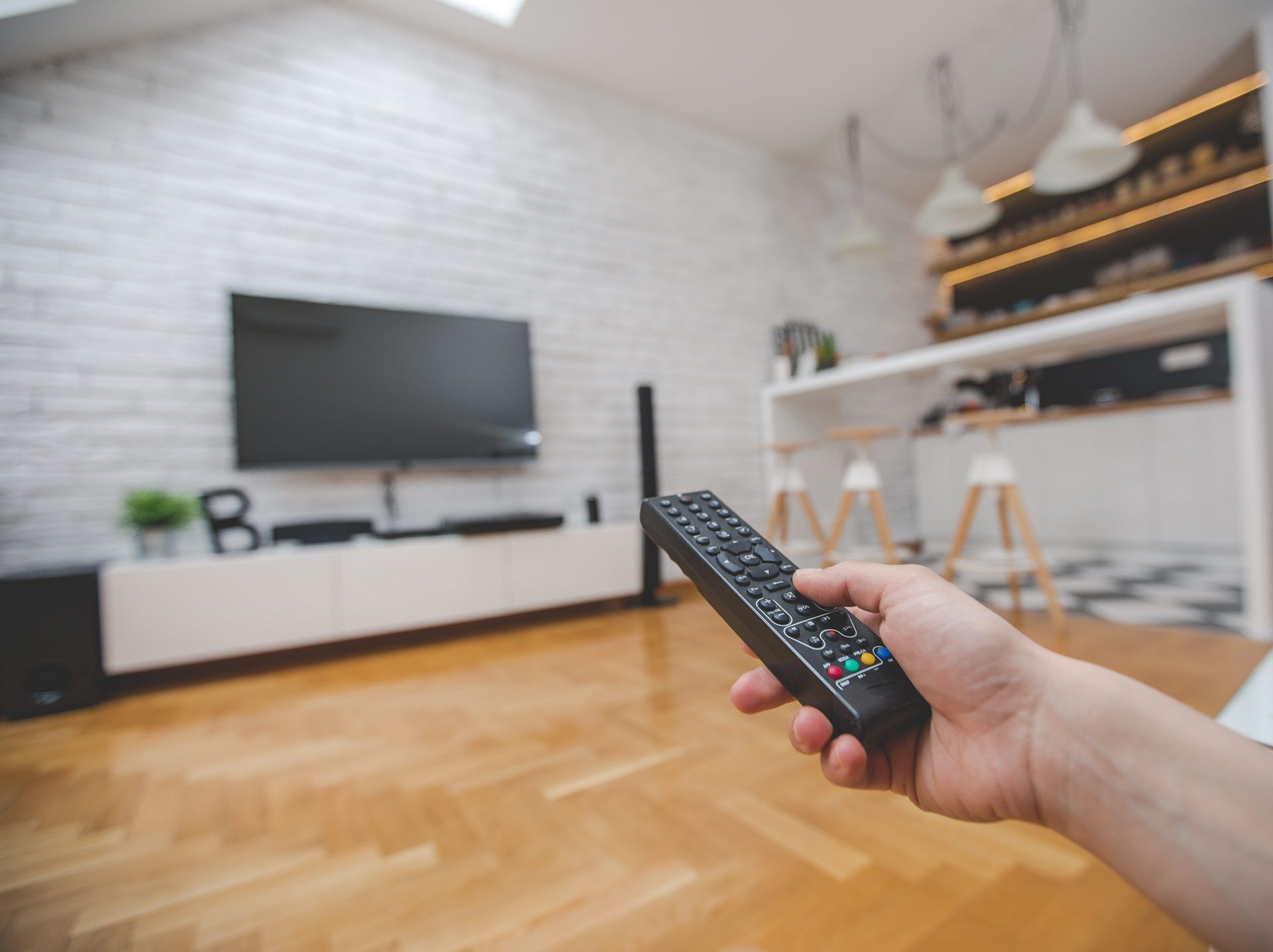 Close-Up of a Female Hand Holding the Remote Control to Change Channels on TV | Mildura, Vic | a & R Electronics