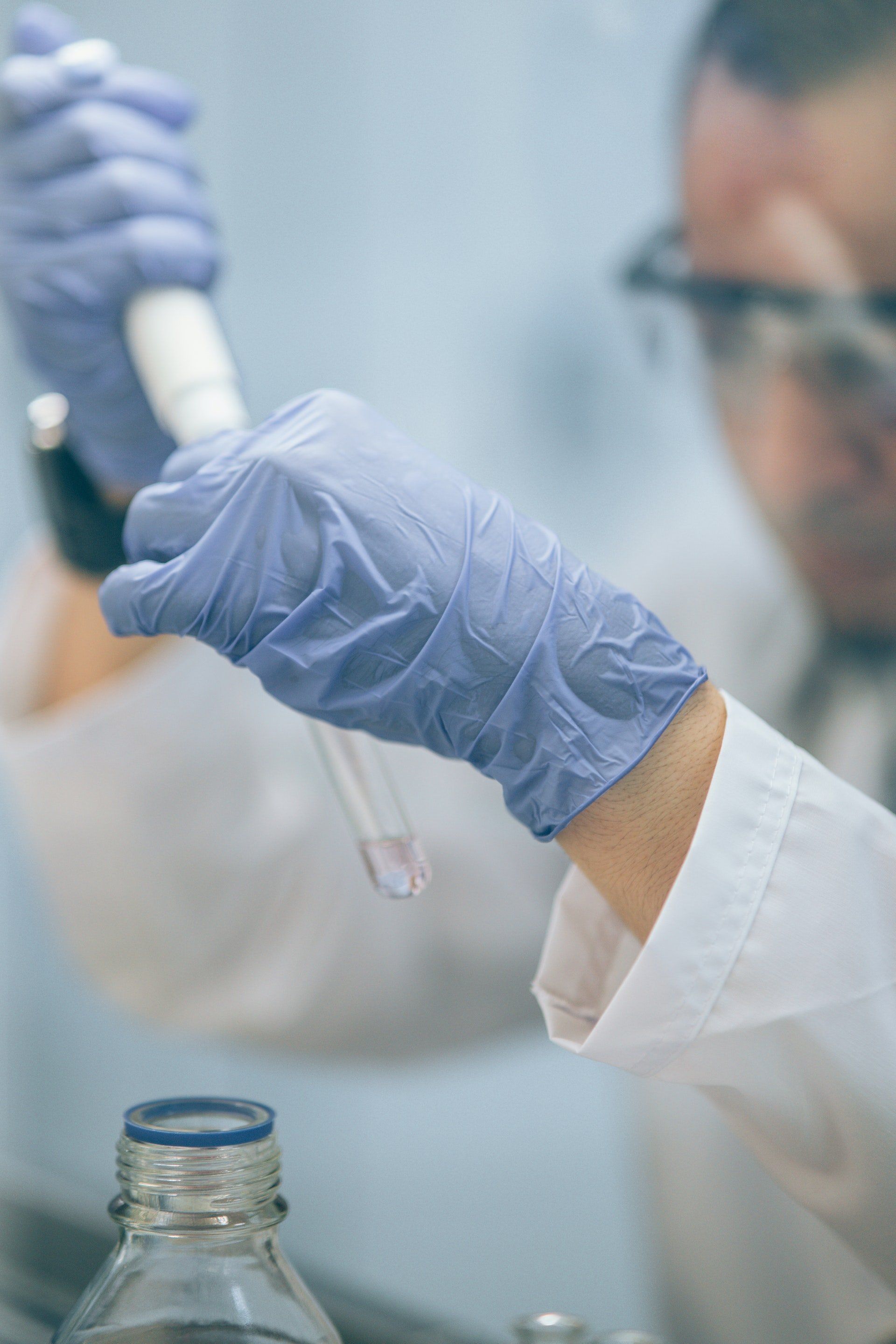 a scientist carefully mixing chemicals in vial