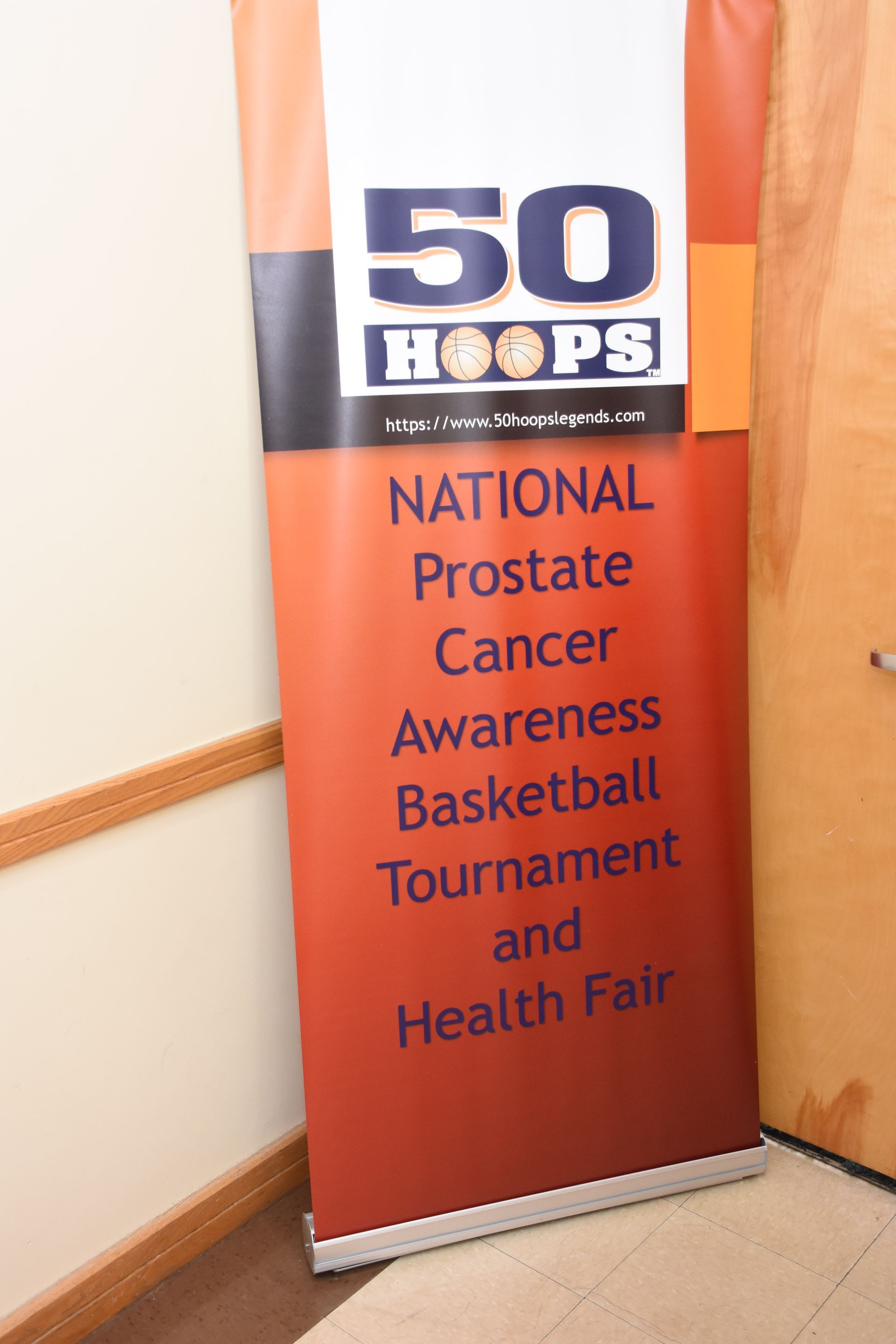 Banner for National Prostate Cancer Awareness Basketball Tournament and Health Fair. Orange, white, and black colors.
