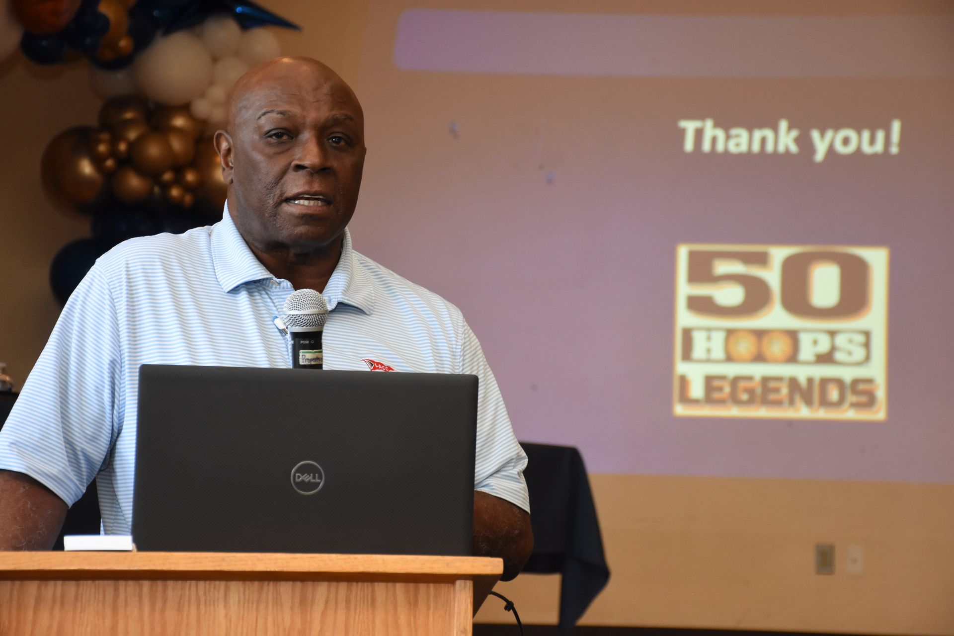 Man speaking at podium, 