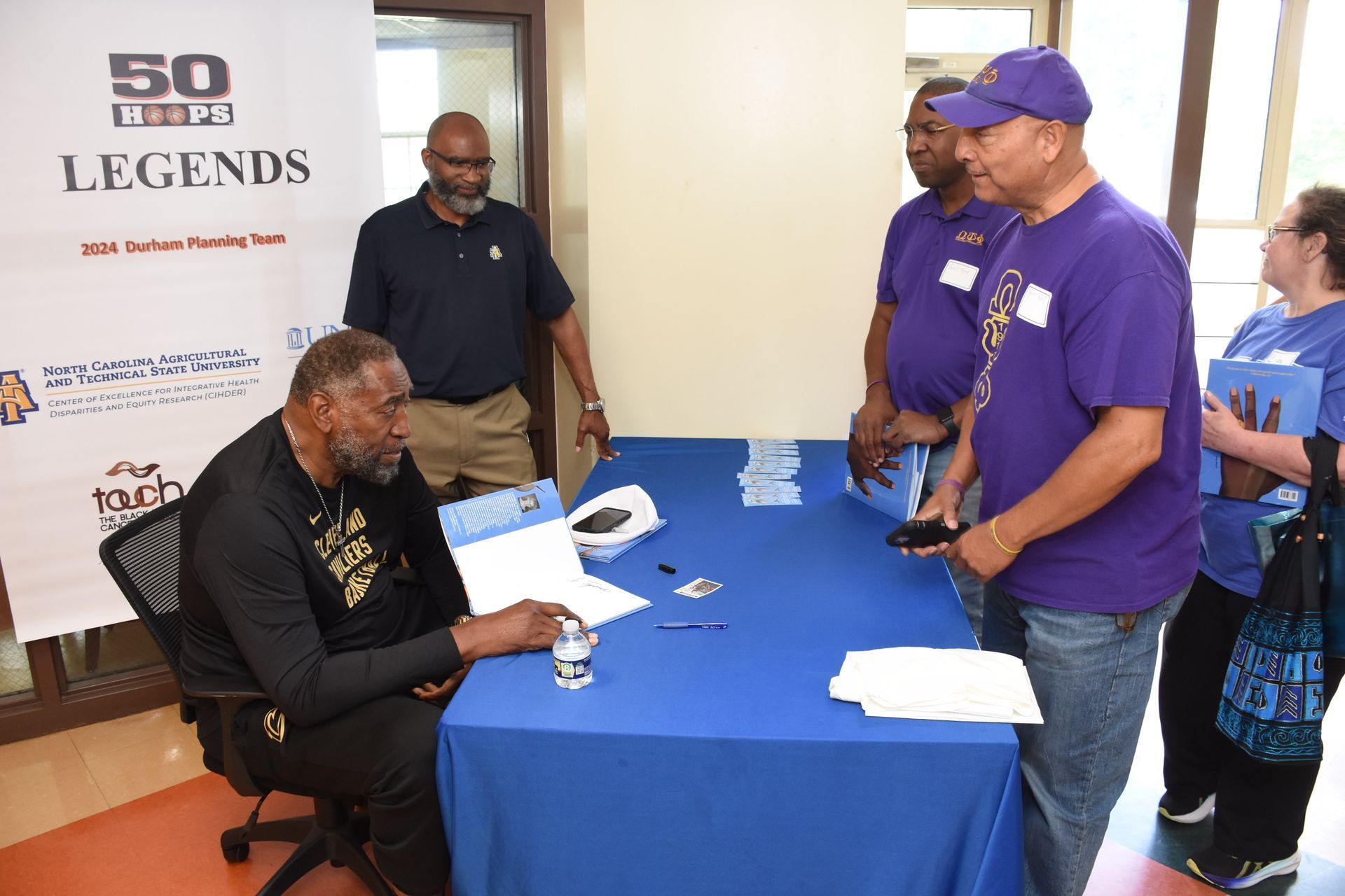 People at a signing table with a 