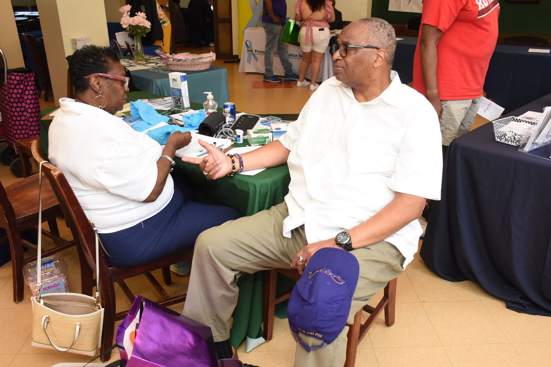 Two people seated, conversing at a table.
