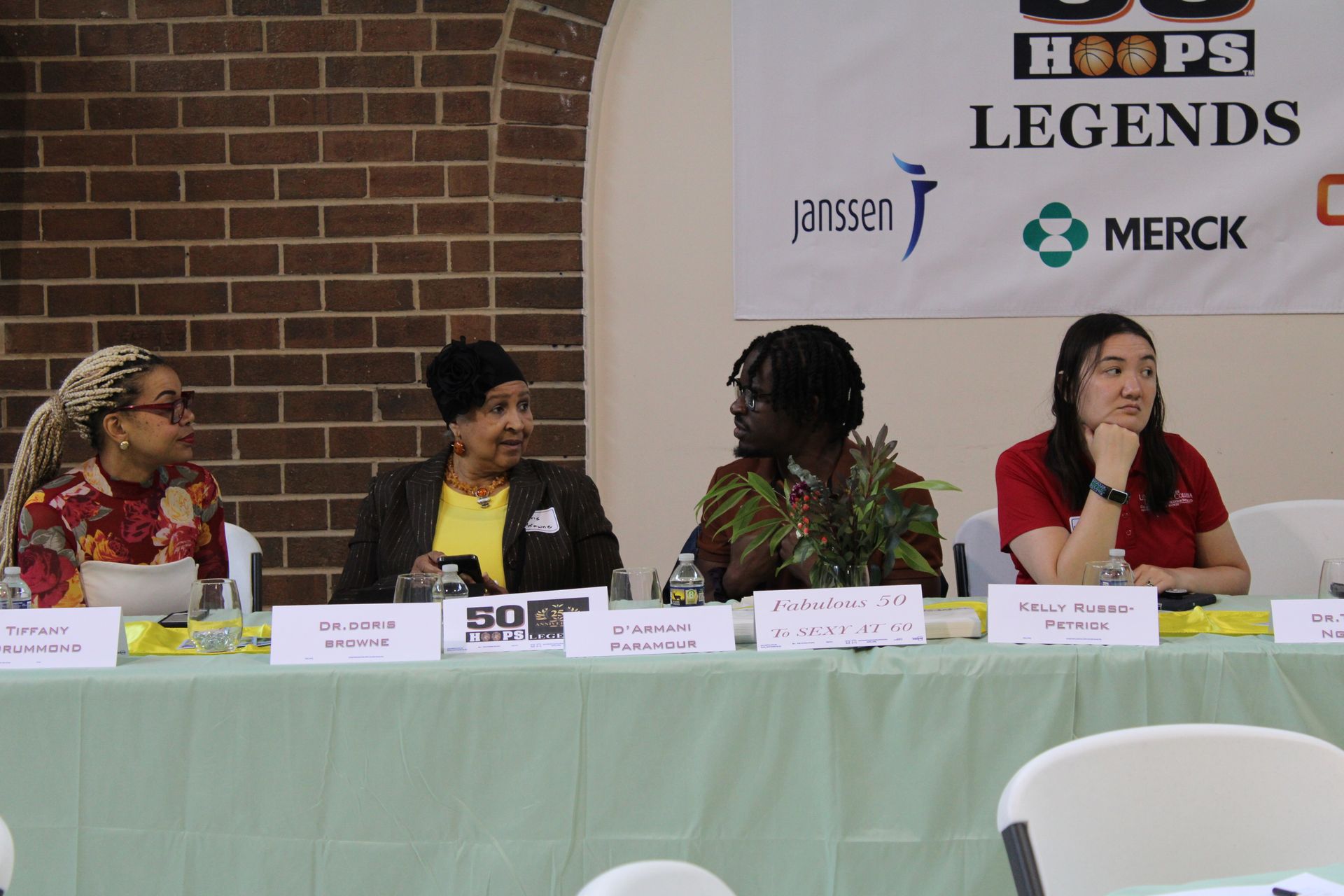 Panel of women at a table with a banner that reads 