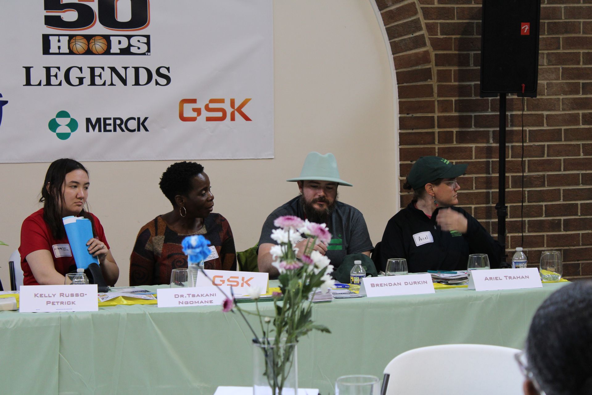 Panel discussion: Four people seated at table with 