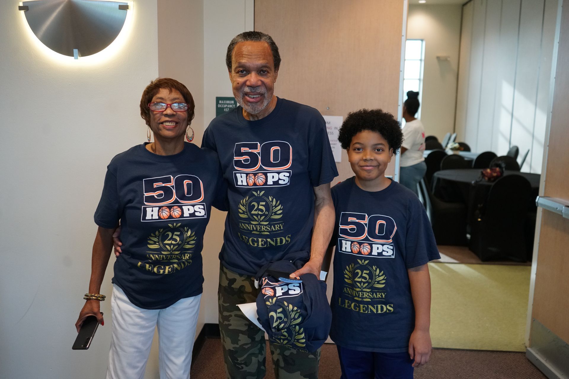Three people wearing matching blue 