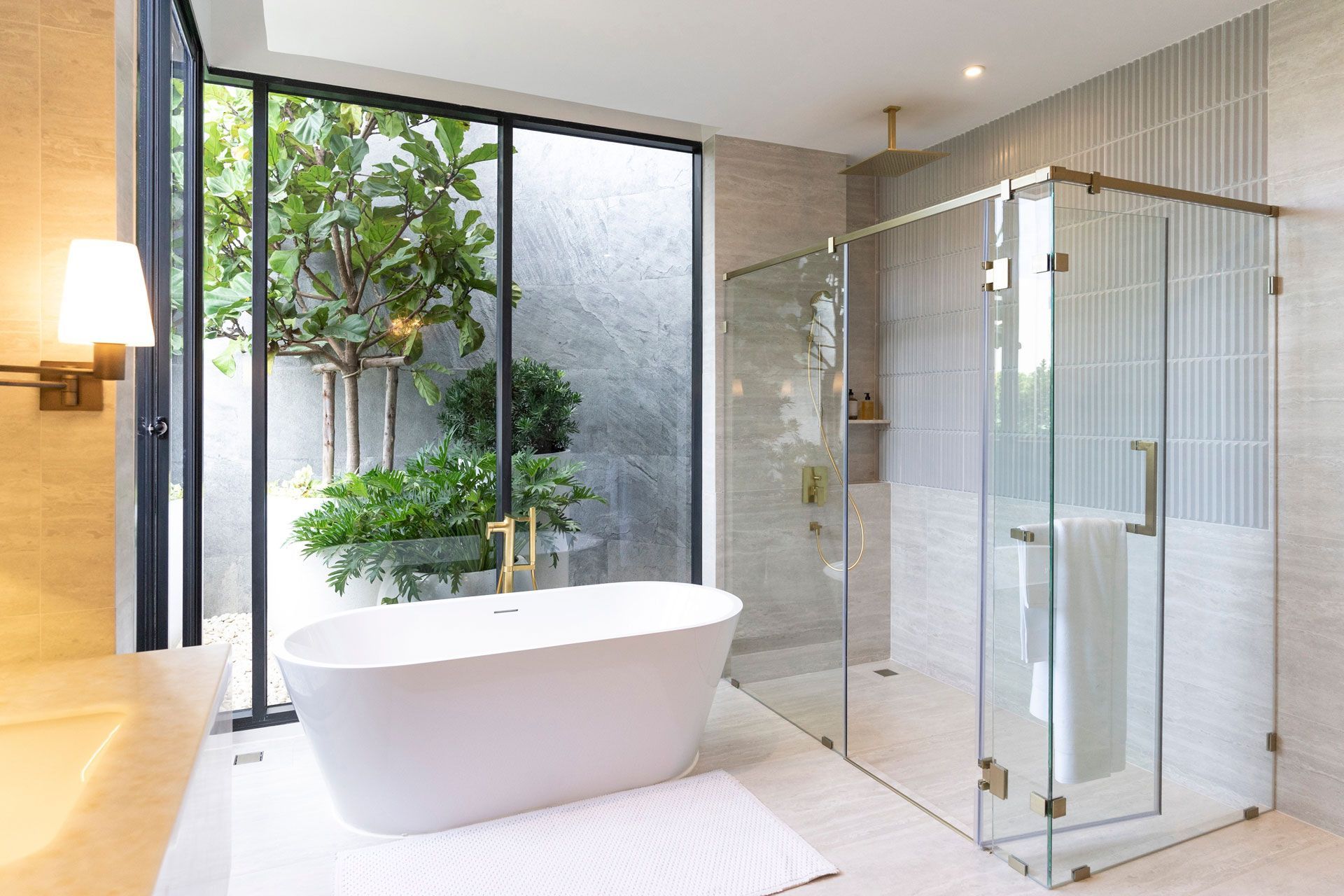 A bathroom with a bathtub and a walk in shower
